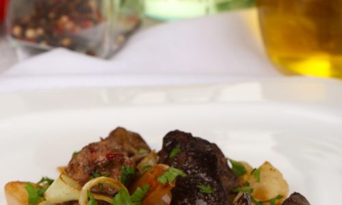 Appetizing fried chicken livers on plate close-up